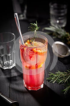 Pink fruit cocktail or lemonade on black wooden table