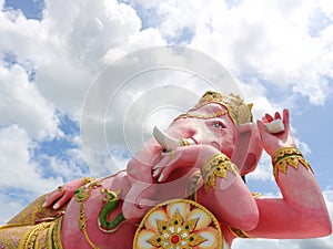 Pink Ganesha statue reclining and sky with cloud.