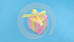 Pink gift box on blue background.