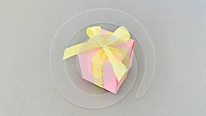 Pink Gift box on grey background.