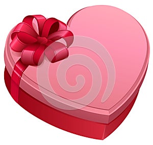 Pink gift box in heart shape. Gift box tied with bow