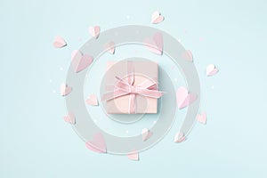 Pink gift or present on blue background top view. Birthday, Woman or Mothers Day greeting card