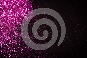 Pink glitter on black backgrund with copy space