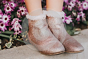 Pink glitter boots on child`s feet