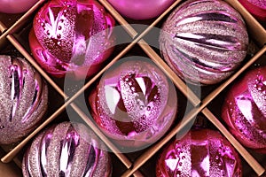 Pink glitter Christmas tree balls in cardboard box