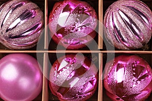 Pink glitter Christmas tree balls in cardboard box