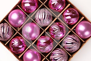 Pink glitter Christmas tree balls in cardboard box