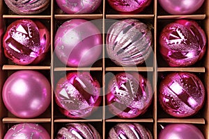 Pink glitter Christmas tree balls in cardboard box