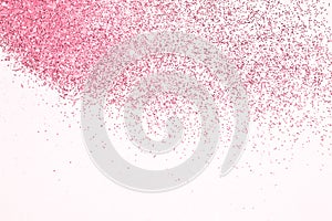 Pink glitter sparkles on white background