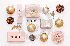 Pink and gold christmas gifts isolated on white background. Wrapped xmas boxes, christmas ornaments, baubles and pine cones.