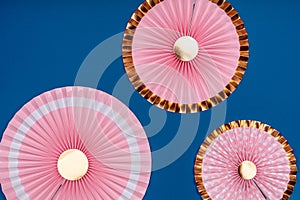 Pink and golden paper fans on classic blue drop