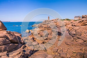 Pink Granit Stones and Cap Frehel Lighthouse and Atlantic Ocean on a Sunny Summer Day in Bretagne, France