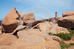 Pink granite boulders and lighthouse in ploumanach