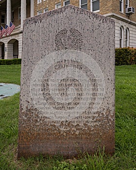 Pink granite historic marker for Fort Inge and Camp Dix CSA on the lawn of the Uvalde County Courthouse.