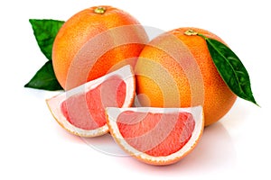 Pink grapefruits with green leaves isolated on white