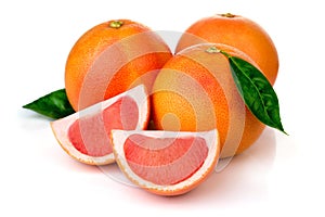 Pink grapefruits with green leaves isolated on white