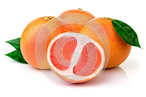 Pink grapefruits with green leaves isolated on white