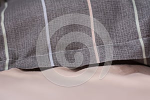 Pink gray bed linen. Pink sheet pillow.