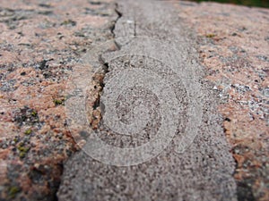 Pink-gray granite and old cement. background, texture. the parapet of the River. Granite stone abstract texture background.