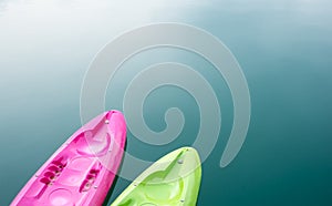 Pink and green canoe on lake