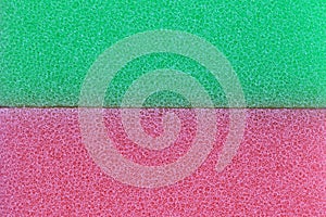 Pink and green sponge surface background.