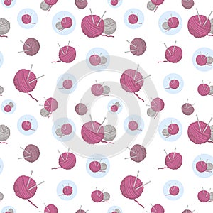 Pink and grey balls of thread knitting needles in blue circle and big knitting balls on white background seamless pattern.