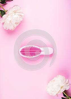 Pink hair brush in white peonies frame