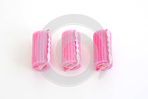 Pink hair curlers isolated on white background