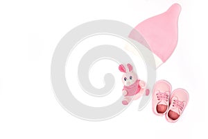 Pink hat, toy and shoes for babies top view. copy space. horizontal image