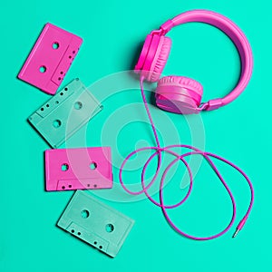 Pink headphones and audio cassettes with CDs