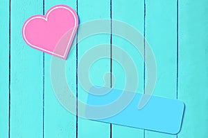 pink heart on a blue wooden background and a blue plate. copy space. Background for weddings, valentines day. background