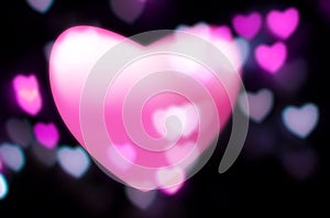 Pink heart blurs into out-of-focus lights