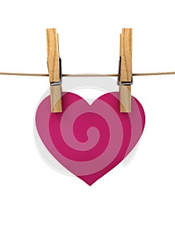 Pink heart hanging on a string pinned clothespins, a concert