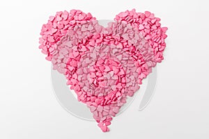 Pink heart made of many smaller hearts on a white background