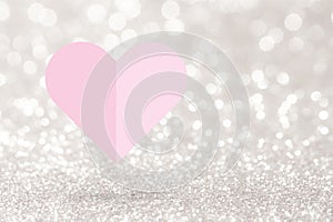 Pink heart paper fold on silver glitter background