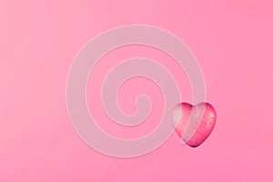 Pink heart on pastel pink background