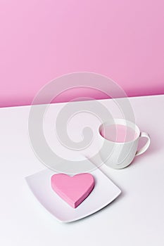 Pink heart in a plate and cup of pink milkshake
