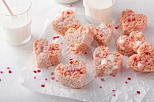 Pink heart shaped rice krispie treats served with milk