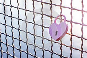 Pink heart symbol of love. Metal lock Valentines day background