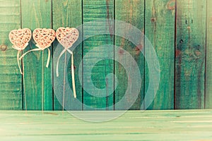 Pink heart on wooden background.