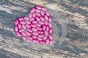 Pink heart on wooden background