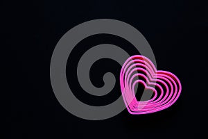 pink hearts on black background for valentine`s day advertising baner