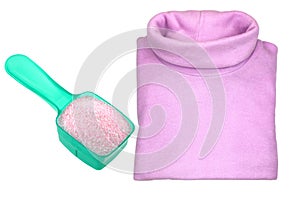 A pink heat retaining turtleneck shirt next to washing powder