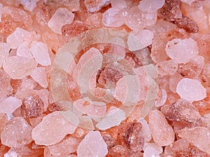 Pink himalayan rare salt crystal cloce-up background. Spice and vegetarian concept