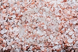 Pink Himalayan salt background top view.