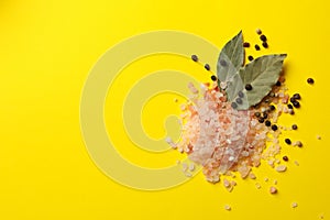 Pink himalayan salt and spices on yellow background