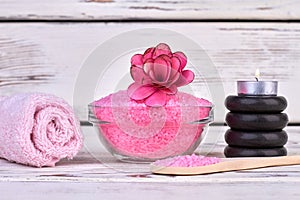 Pink himalayan salt with towel and black stones.