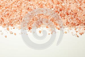 Pink himalayan salt on white background, space for text