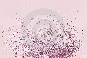 Pink holographic glitter confetti in the form of stars on pink background Flat lay top view copy space. Festive holiday pastel