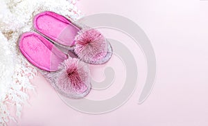 Pink home velvet slippers and white plaid on a pink background